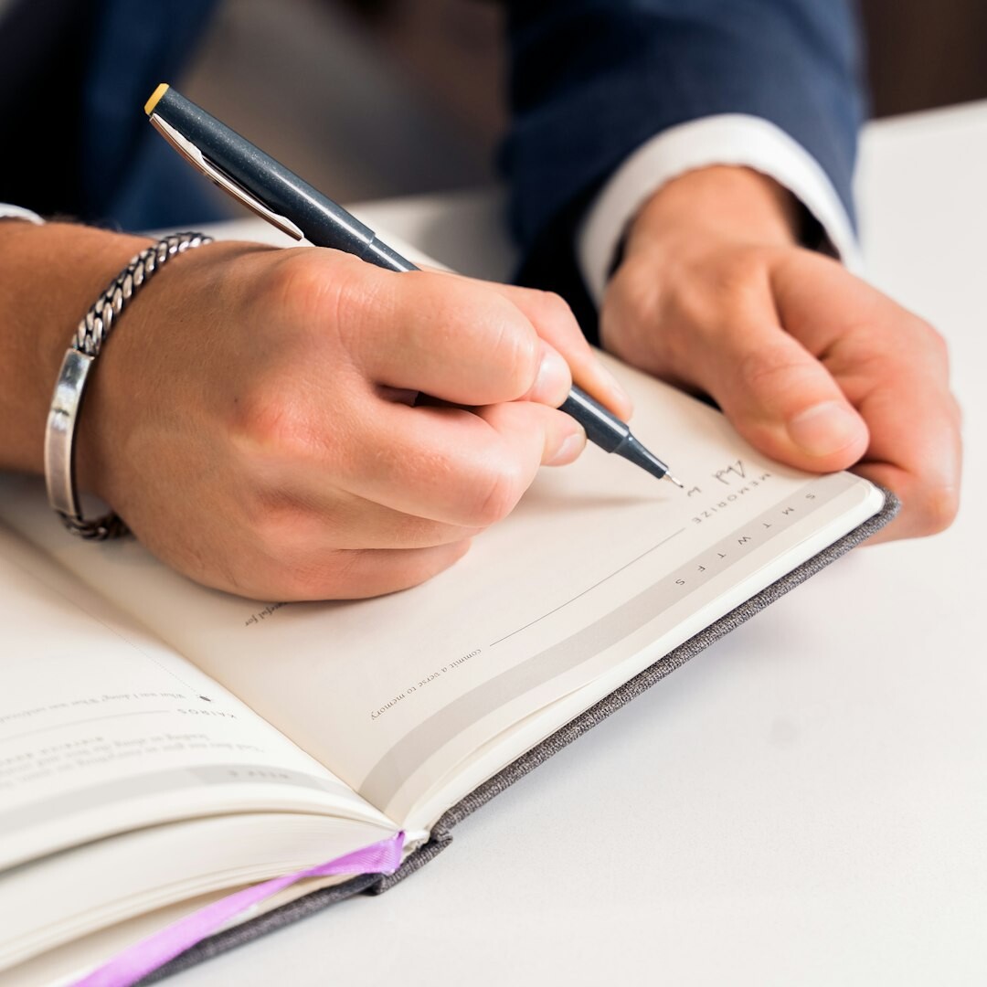 Close up of hands writing in a journal