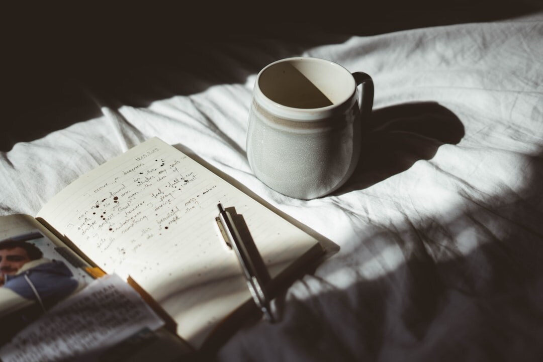 Open notebook with communication notes and a warm cup of tea