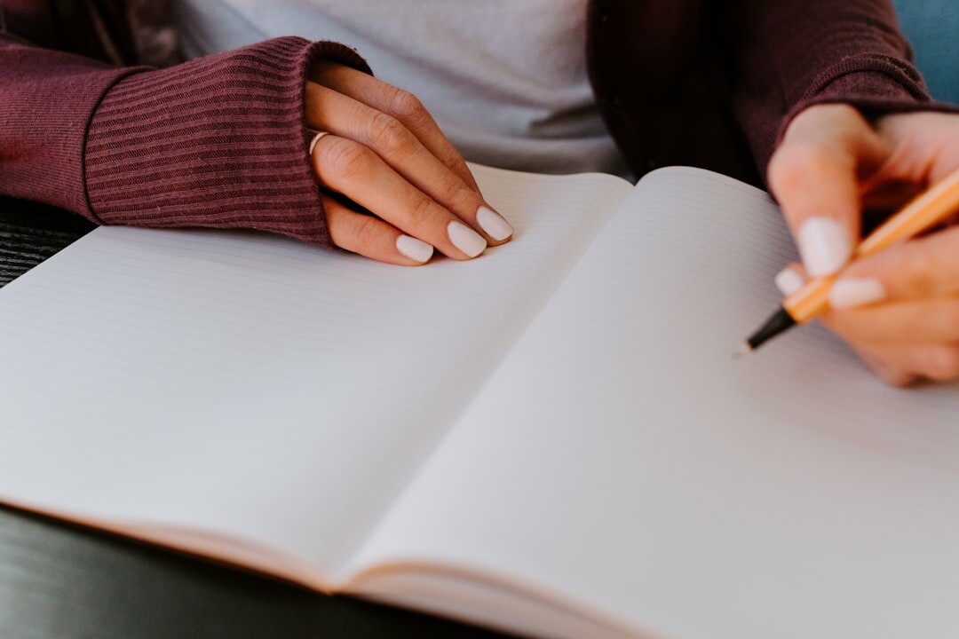 Brazilian woman writing in a notebook at a bright desk