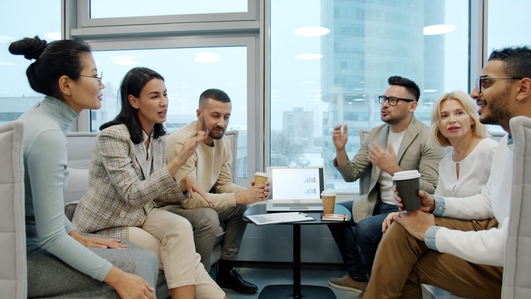 Two Brazilian colleagues talking with open body language in an office